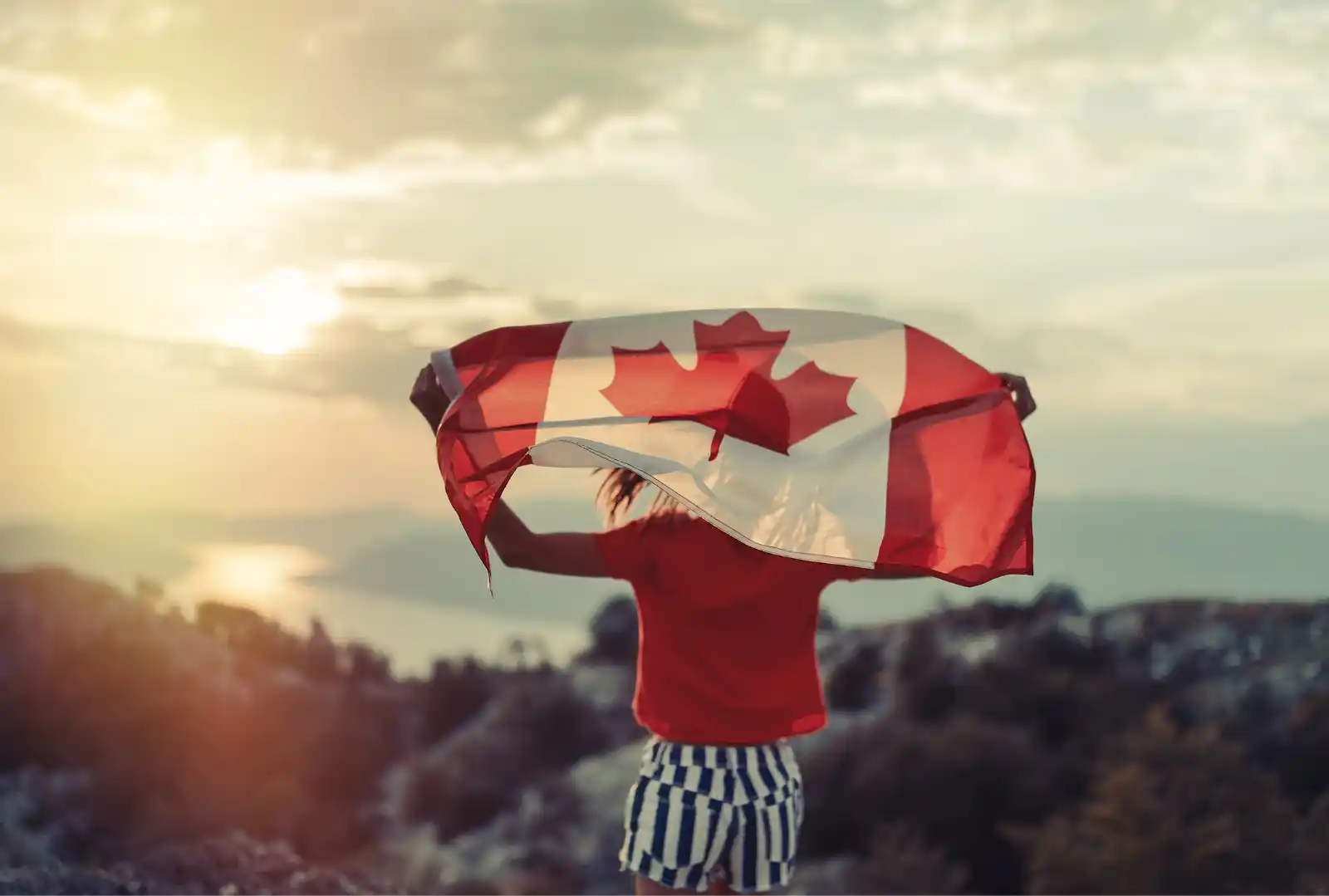 Canada to join the Apostille Convention represented by a person holding a Canadian flag